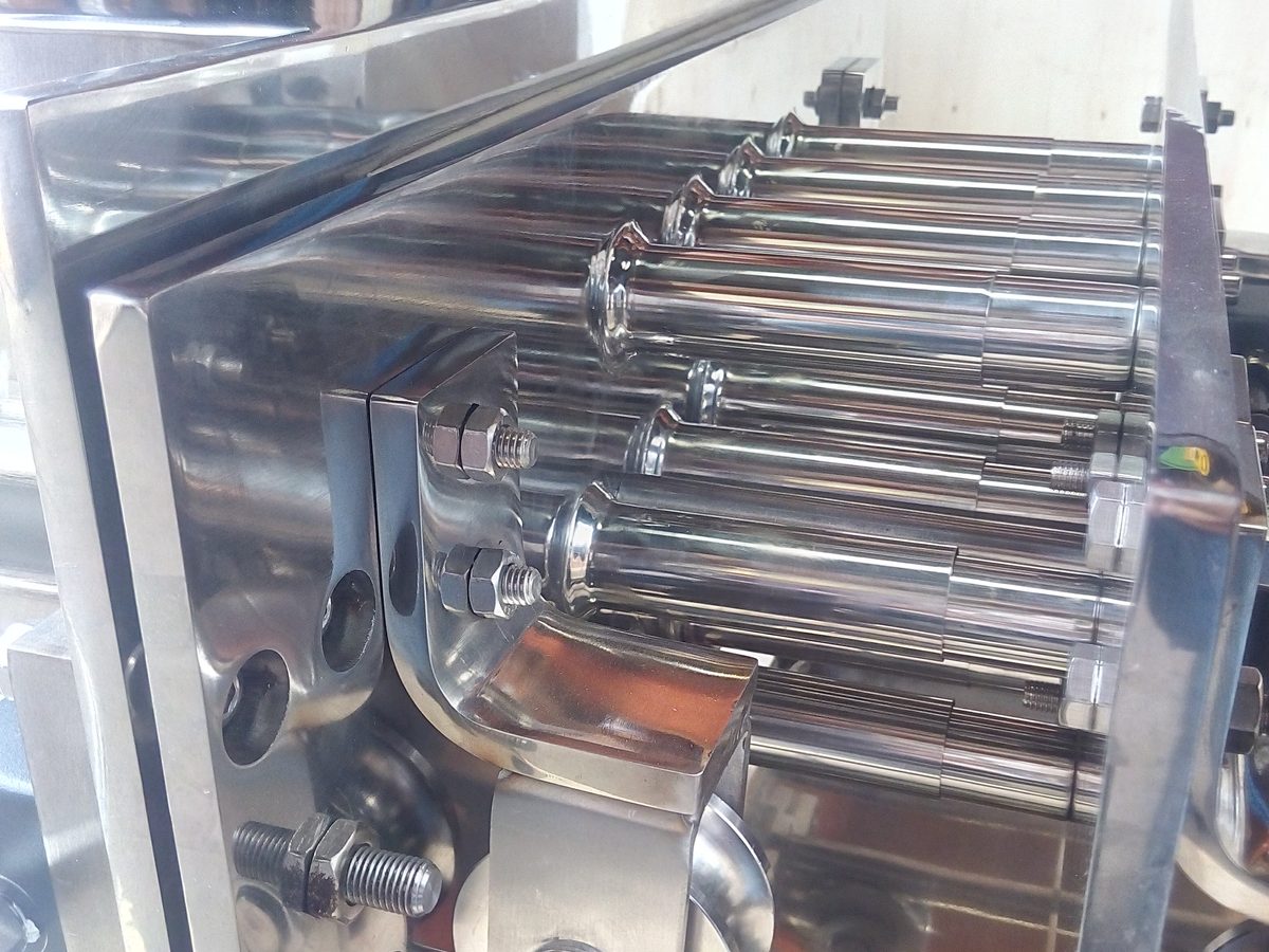 Multi-row stainless steel magnetic bar assembly with mounting plates and rollers for a drawer-type grate magnet